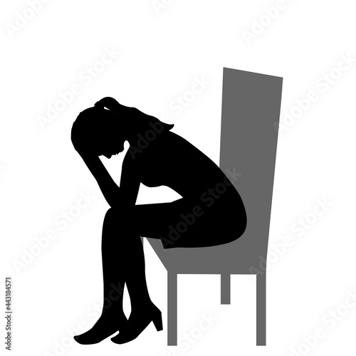 Sad woman sitting on a chair and  holding her head in her hands