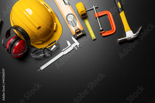 Work safety. Construction site protective equipment on wooden background, flat lay, copy space, top view © A Stockphoto