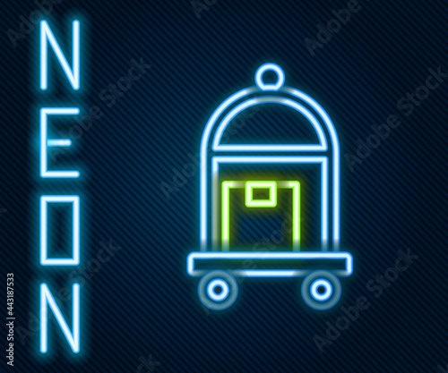 Glowing neon line Hotel luggage cart with suitcase icon isolated on black background. Traveling baggage sign. Travel luggage icon. Colorful outline concept. Vector