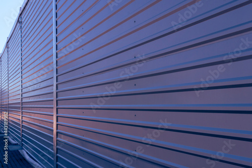 Trapezoidal sheet placed on the facade of the warehouse. Perspective view.