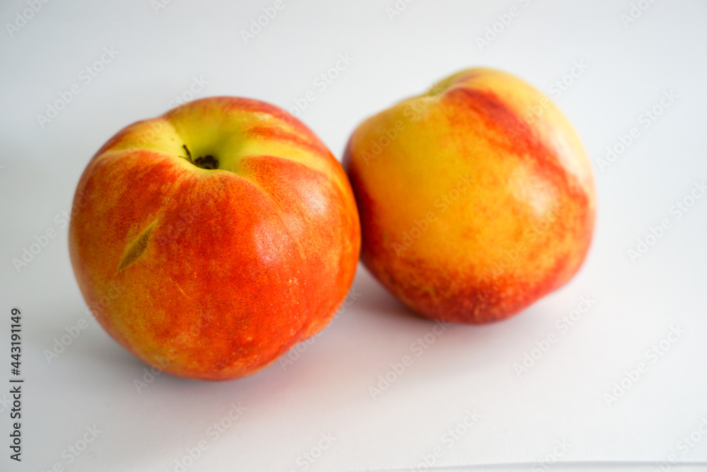 Side view of two nectarines on white background Side view of two nectarines on white background