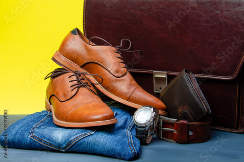 Collection of men's accessories. Men's shoes, jeans, belt, watch, wallet with money and briefcase. Mens accessories background.