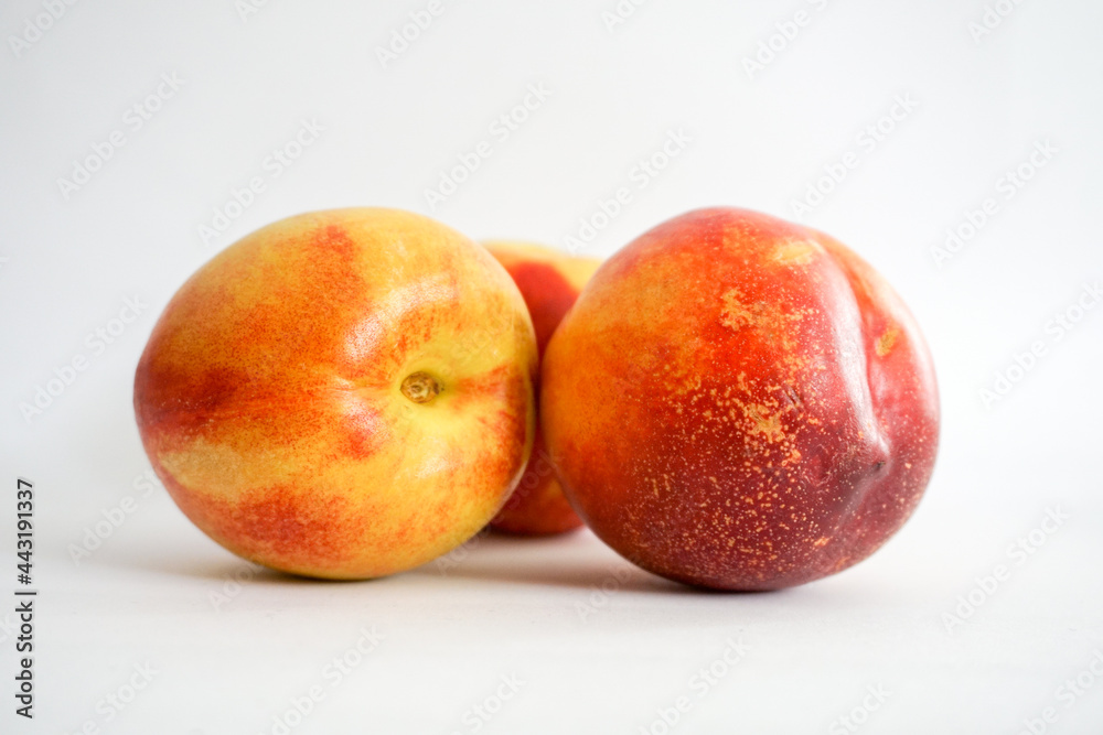 Side view of three nectarines on white background Side view of three nectarines on white background