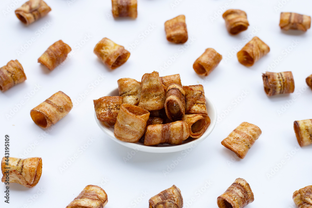 Dried banana rolled chips on white. Dried banana rolled chips on white.