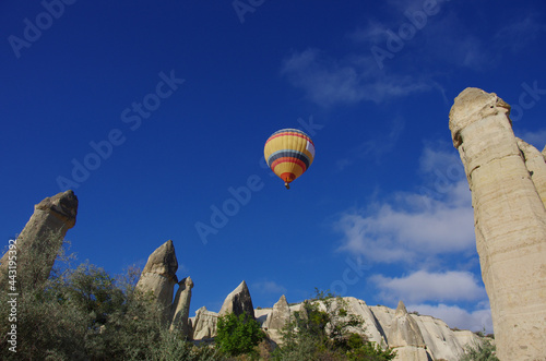 Love Valley, a colorful hot air balloon flies in the blue sky, Cappadocia, Turkey