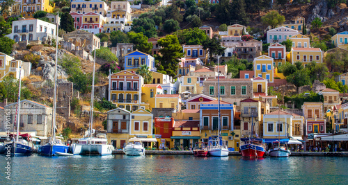 Greece. Dodecanese. Islands Symi.Colorful houses and boats and yachts .