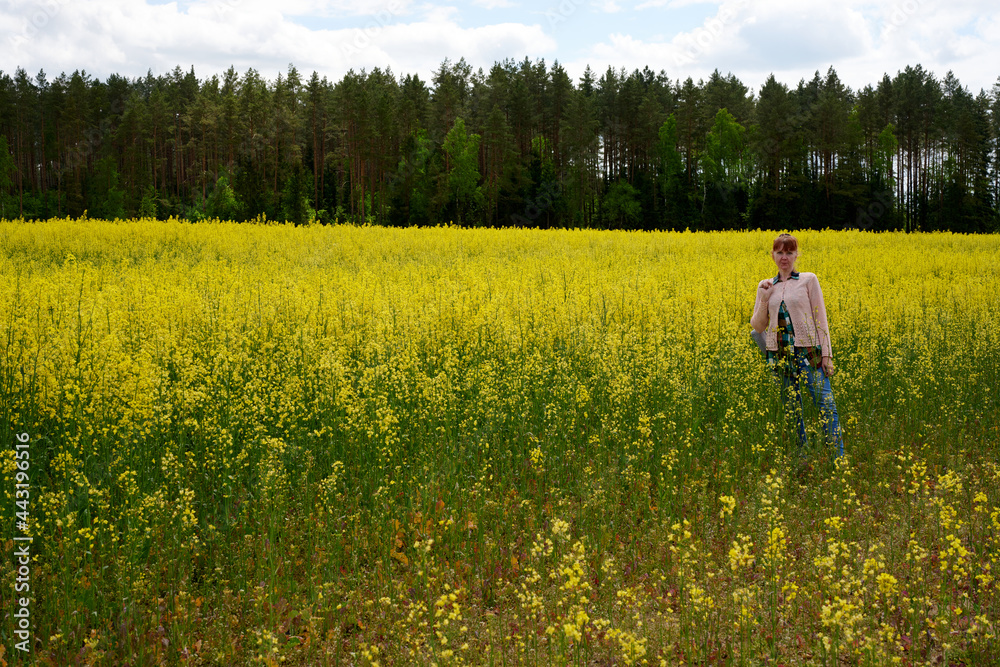 Photo of rapeseed field with woman