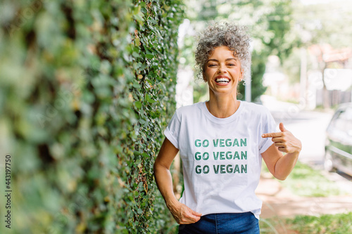 Happy mature woman advocating for veganism outdoors