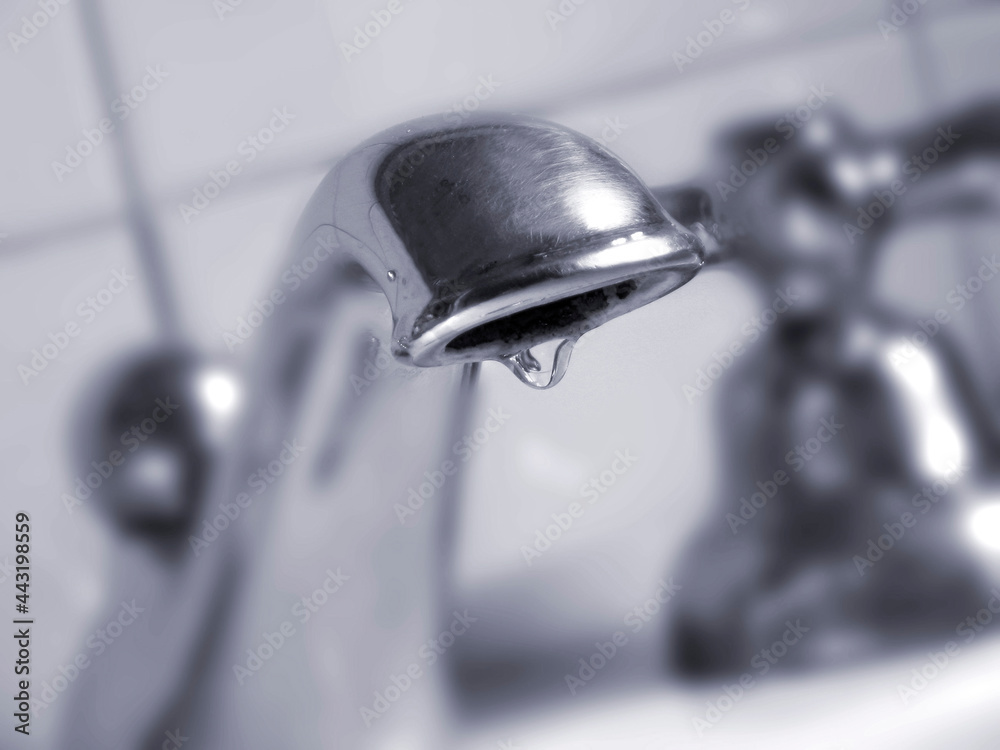 water drop from a bathroom faucet water drop from a bathroom faucet