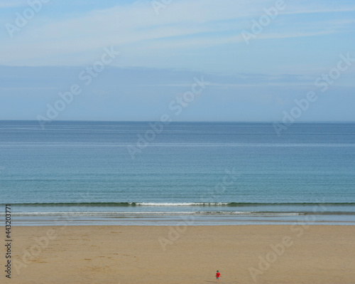 Boy running to the sea on the beach Hayle St Ives Bay Cornwall