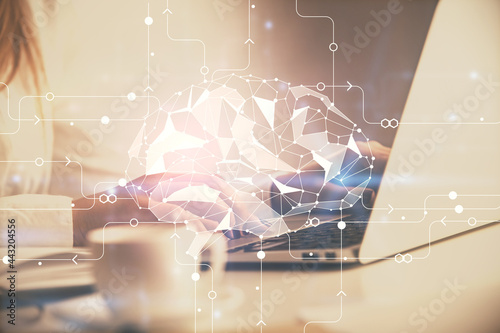 Multi exposure of woman hands working on computer and human brain hologram drawing. Ai tech concept.