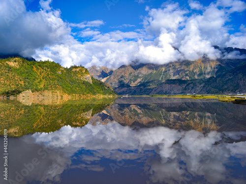 Mountains and reflection on lake with clouds