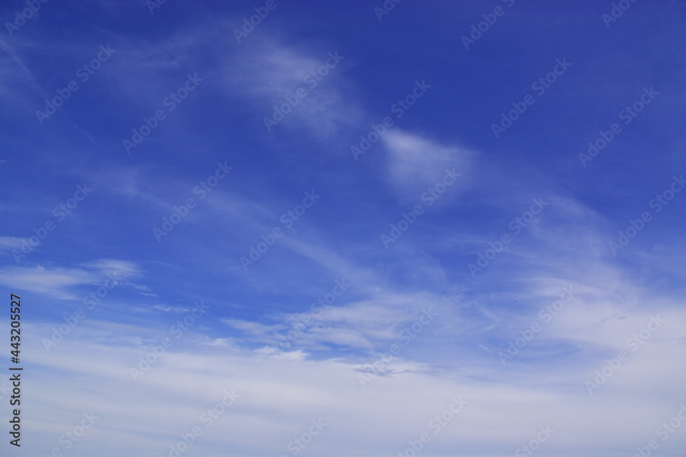 Light cirrus clouds in the blue sky