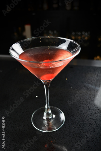 bartender special cold red alcohol bloody mary cocktail with cherry juice in tall glass goblet on black background luxury hotel pub iced beverage menu