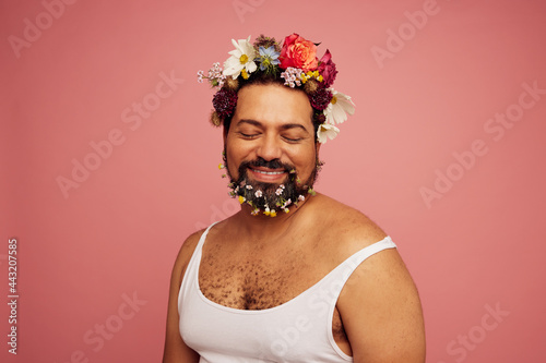 Genderqueer wearing flowers on head and beard photo