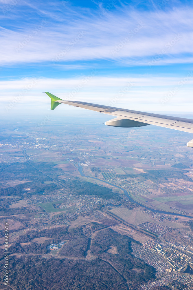 View from the airplane window at a beautiful blue sunrise and the airplane wing in clear sky. View from the airplane window at a beautiful blue sunrise and the airplane wing in clear sky.