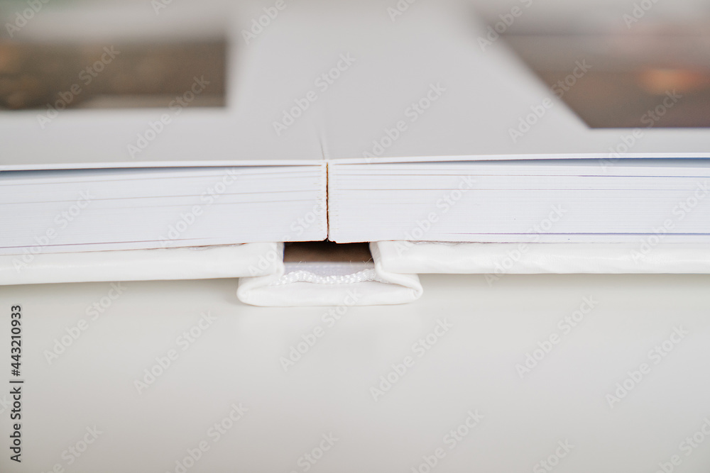 close-up of thick plastic pages white book in leather binding. photobooks. close-up of thick plastic pages white book in leather binding. photobooks.