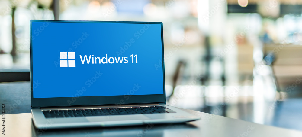 Laptop computer displaying logo of Windows 11 Stock Photo | Adobe Stock