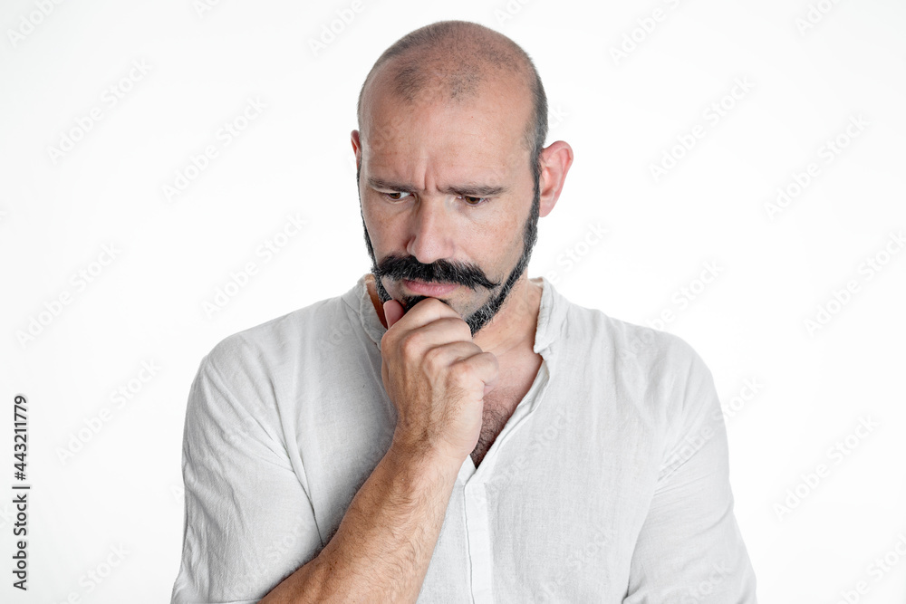 Caucasian man with mustache and beard making dubious and analytical expression, dressed in white on white isolated background