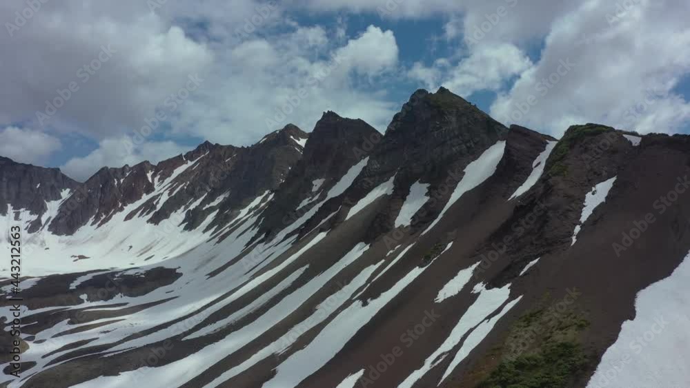 custom made wallpaper toronto digitalAerial view of mountain chain on Kamchatka peninsula. Drone 4k footage, dramatic aerial view. Snowy mountains in July 2021. Clouds moving fast