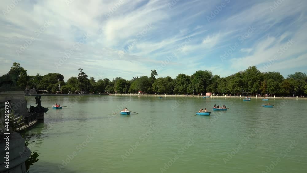 Rowing boats in the Retiro park in Madrid on sunny day with clouds. Rowing boats in the Retiro park in Madrid on sunny day with clouds.