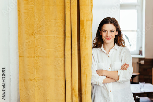 Cute friendly young woman grinning at the camera