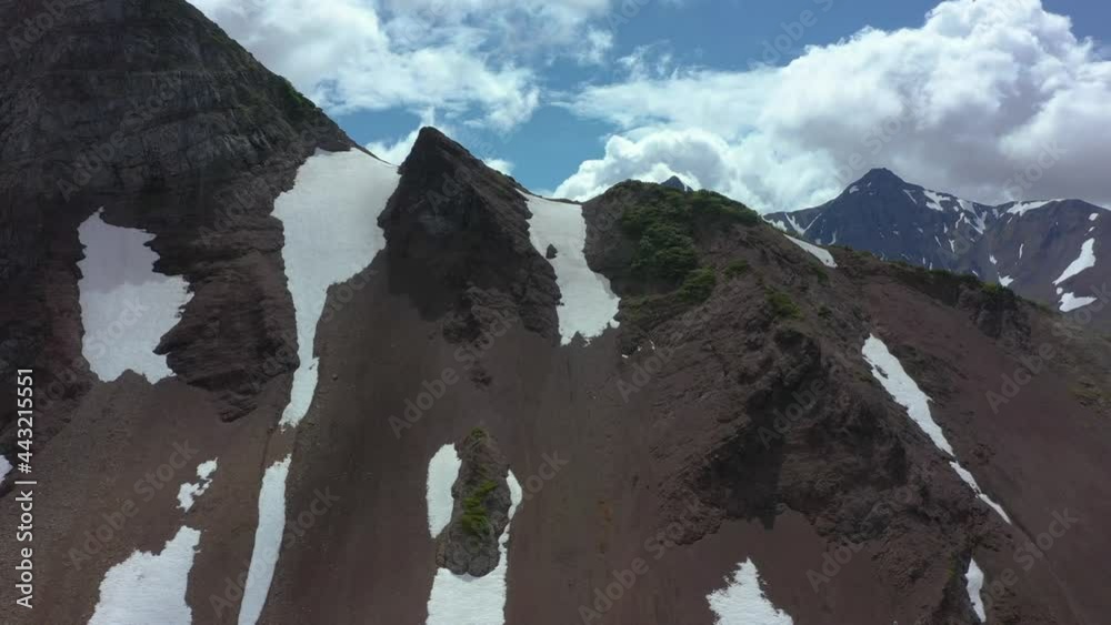 custom made wallpaper toronto digitalAerial view of mountain chain on Kamchatka peninsula. Drone 4k footage, dramatic aerial view. Snowy mountains in July 2021. Clouds moving fast
