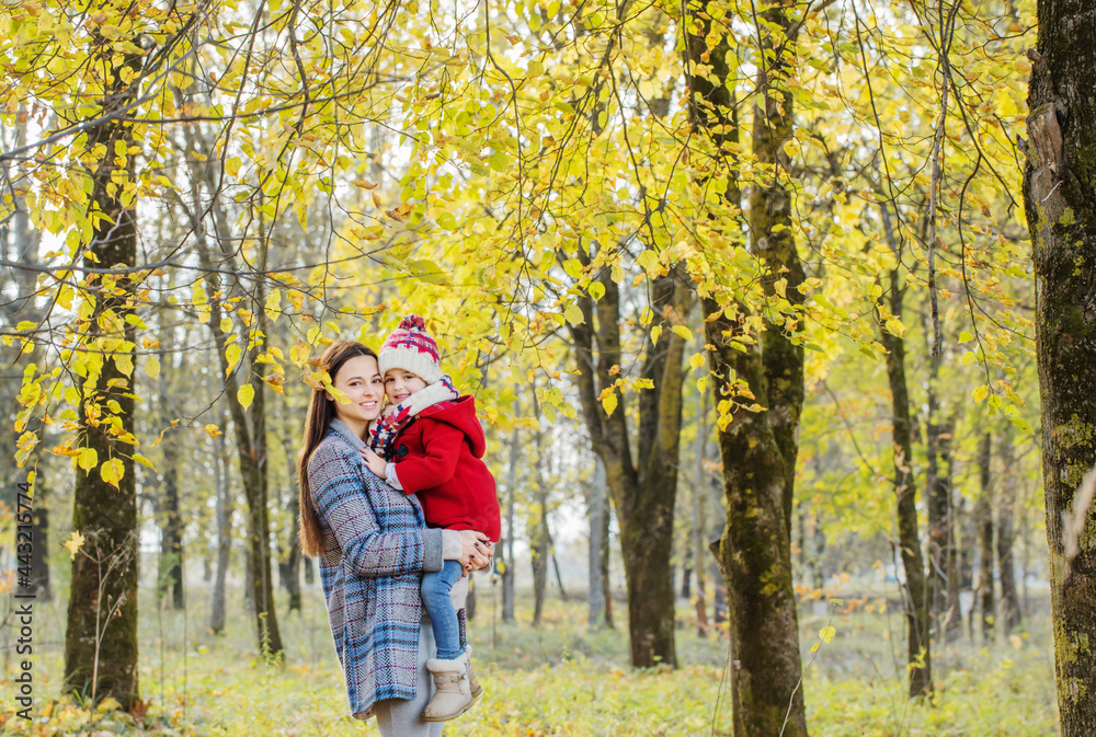 happy mother and daughter in autumn park happy mother and daughter in autumn park