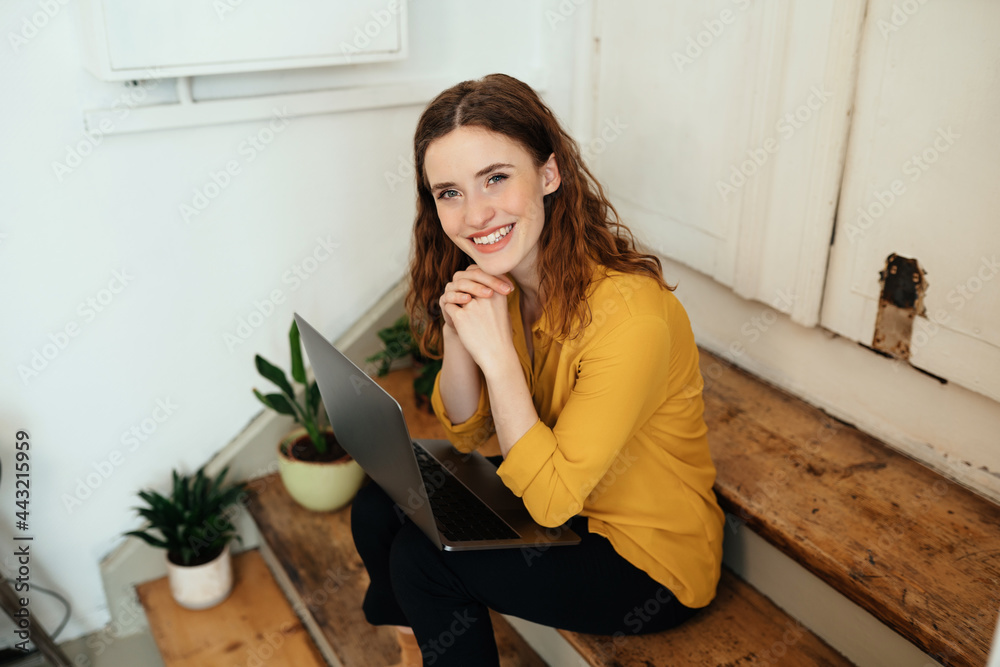 Cute charismatic young woman smiling up at the camera Cute charismatic young woman smiling up at the camera