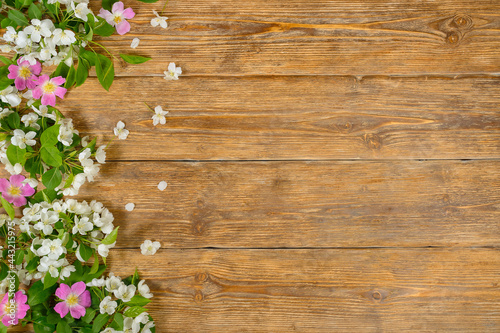  White and pink spring flowers on old wooden table  floral background