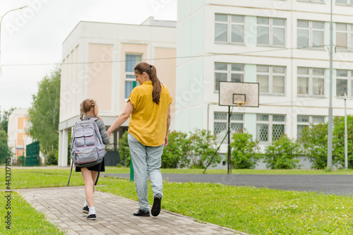 little happy girl with mom going to school education concept. High quality photo