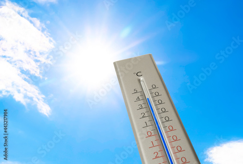 Weather thermometer with high temperature outdoors on hot sunny day. Heat stroke warning