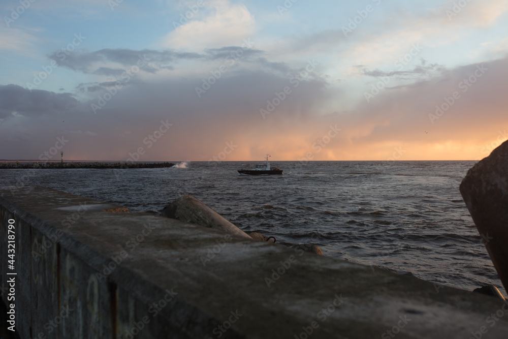 beautiful sunset on the shore of a sandy beach. Waves on the Baltic Sea. Soft focus