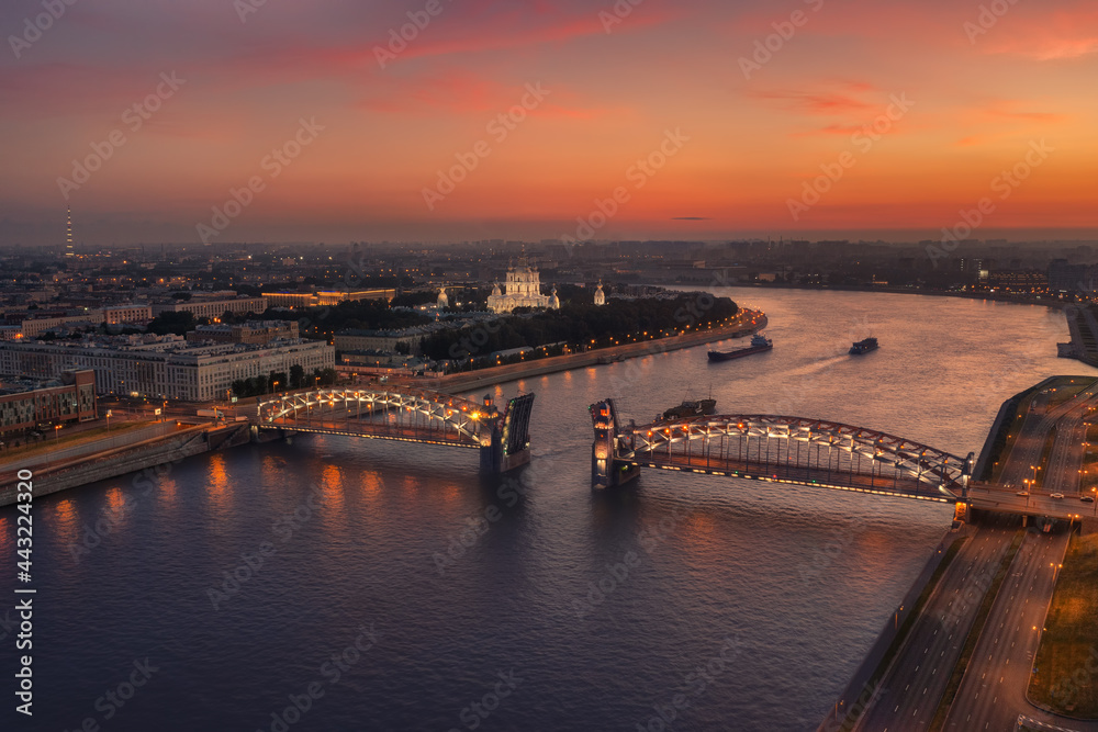 Aerial view of the Peter the Great Bridge ( Bolsheokhtinsky bridge ) and Smolny Cathedral at summer white night time, Saint Petersburg, Russia.