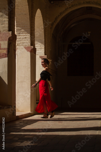 young woman walking inside an ancient building in Spain © Guirado