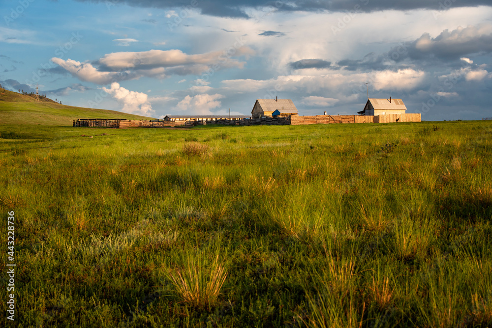 wooden houses in the steppe before the rain