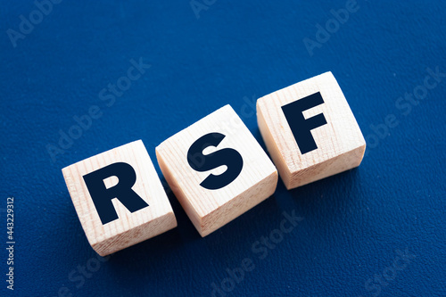 Word RSF. Wooden small cubes with letters isolated on blue background with copy space available. Business Concept image. photo