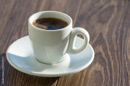 A cup of freshly brewed espresso coffee is on the table. Copy space.