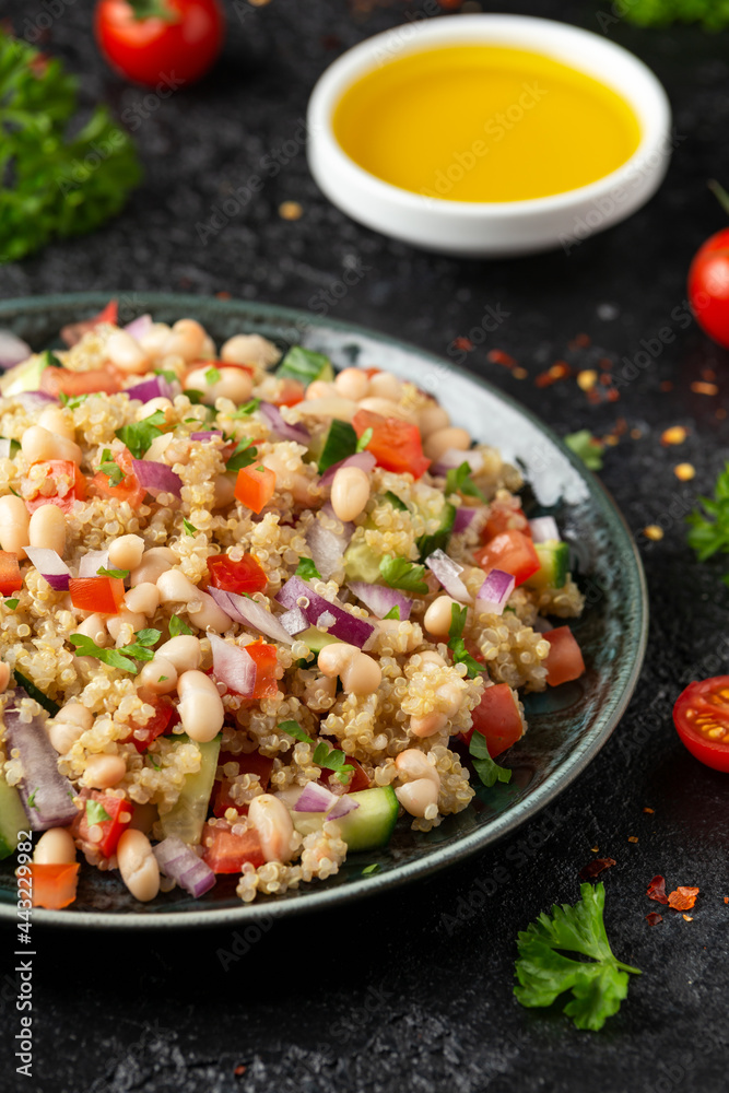 Quinoa white bean salad with cherry tomatoes, cucumber, red onion and herbs. Healthy vegan food Quinoa white bean salad with cherry tomatoes, cucumber, red onion and herbs. Healthy vegan food
