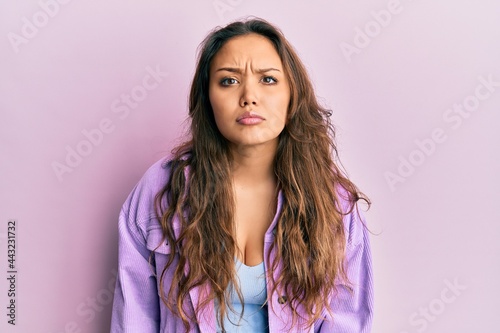 Young hispanic girl wearing casual clothes skeptic and nervous  frowning upset because of problem. negative person.