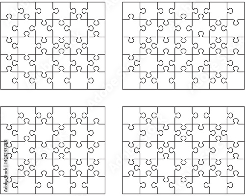 Separate pieces of four white jigsaw puzzles