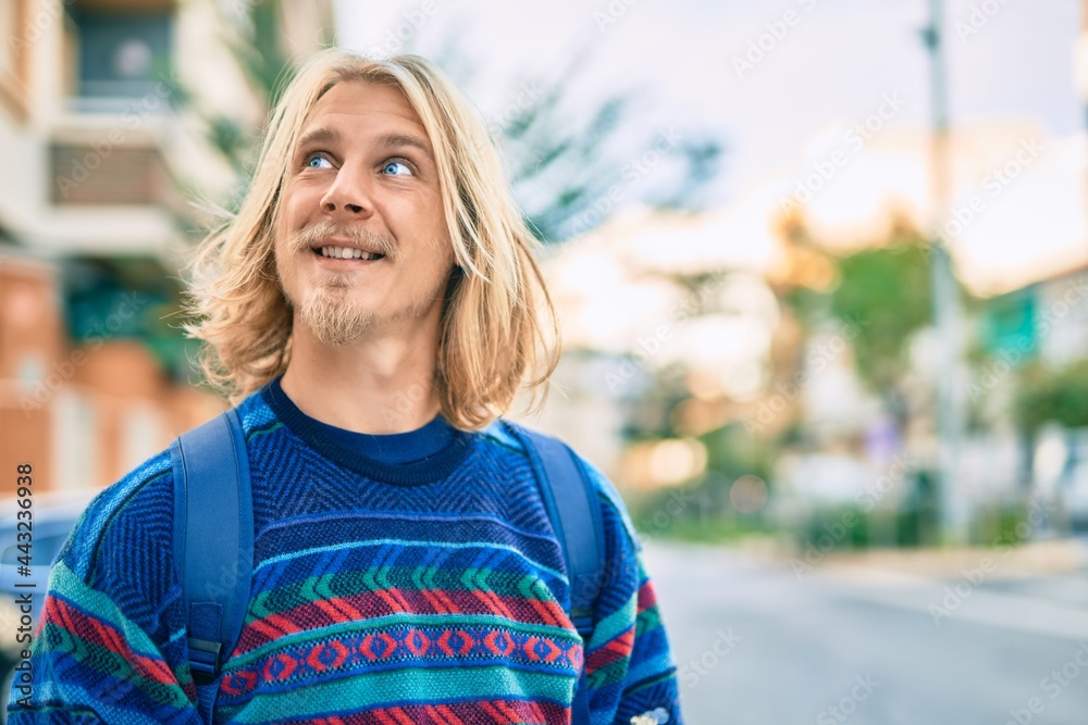 Young scandinavian student man smiling happy standing at the city. Young scandinavian student man smiling happy standing at the city.