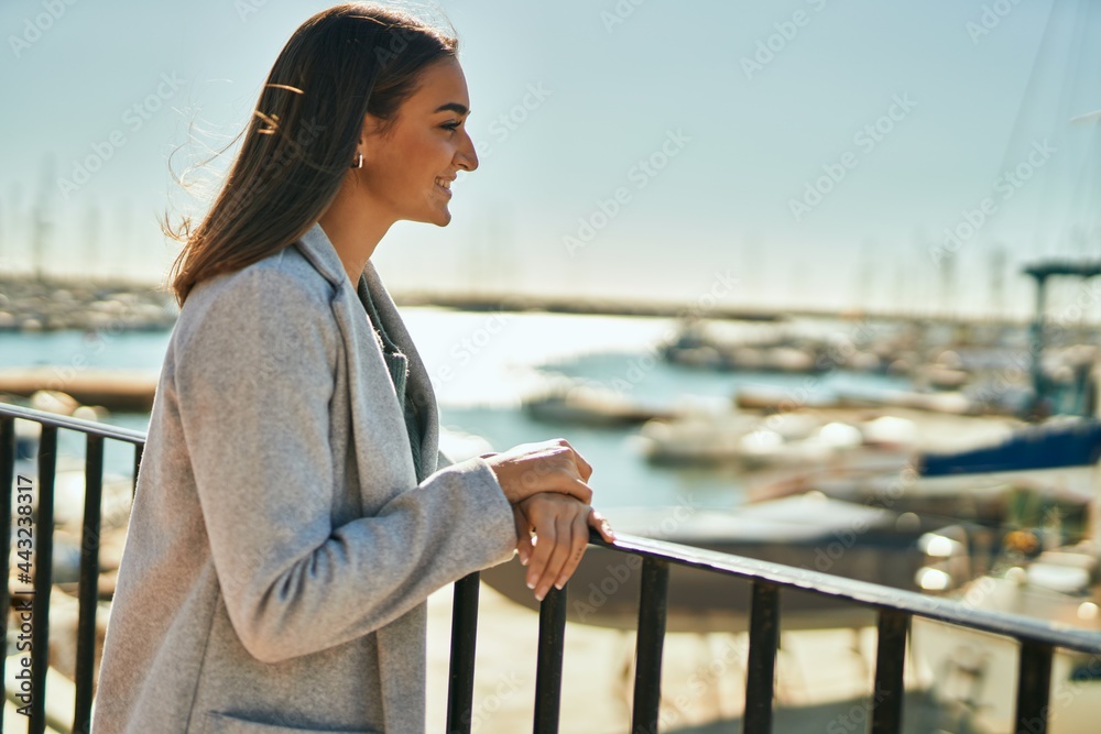Young hispanic girl smiling happy looking to the horizon at the city. Young hispanic girl smiling happy looking to the horizon at the city.