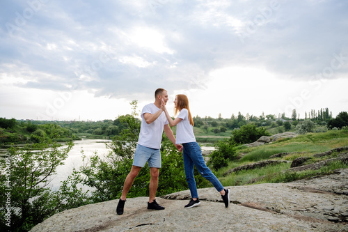 Budget-Friendly Honeymoon Destinations, Romantic getaway, solo couple travel. Couple in love, newlyweds in white t-shirt having fun on nature background. Young couple enjoying in local travel