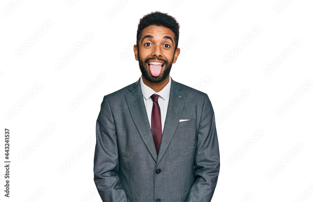 Young african american man wearing business clothes sticking tongue out happy with funny expression. emotion concept.