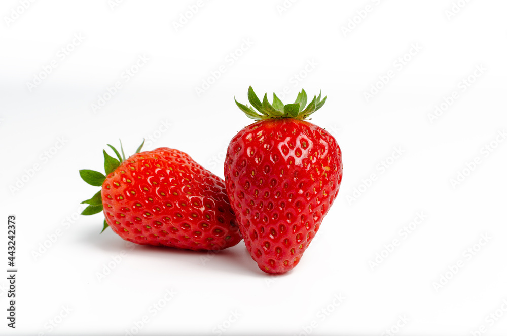 Two ripe red strawberries isolated on a white background Two ripe red strawberries isolated on a white background