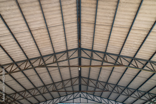 Steel roof structure. Moonlight bulb. Steel structure with roof tiles. Architectural structure of roof. Large roof layout used for industrial plants.