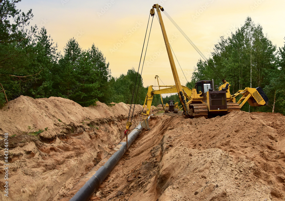 Natural Gas Pipeline Construction. Building of transit petrochemical pipe in forest area. Oil pipeline that would carry tar sands for oil refineries. Fossil fuels and crude. Pipes Welding