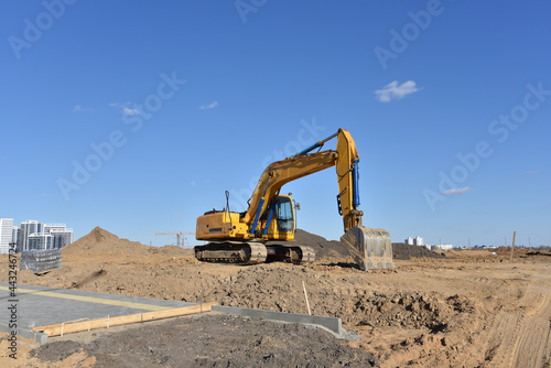 Excavator during earthmoving work at construction site.