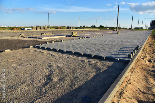 Laying paving slabs at construction site. Process of installing paving bricks in the town pedestrian zone. Screeding the sand for install concrete blocks. Road works on pavement renovation © MaxSafaniuk